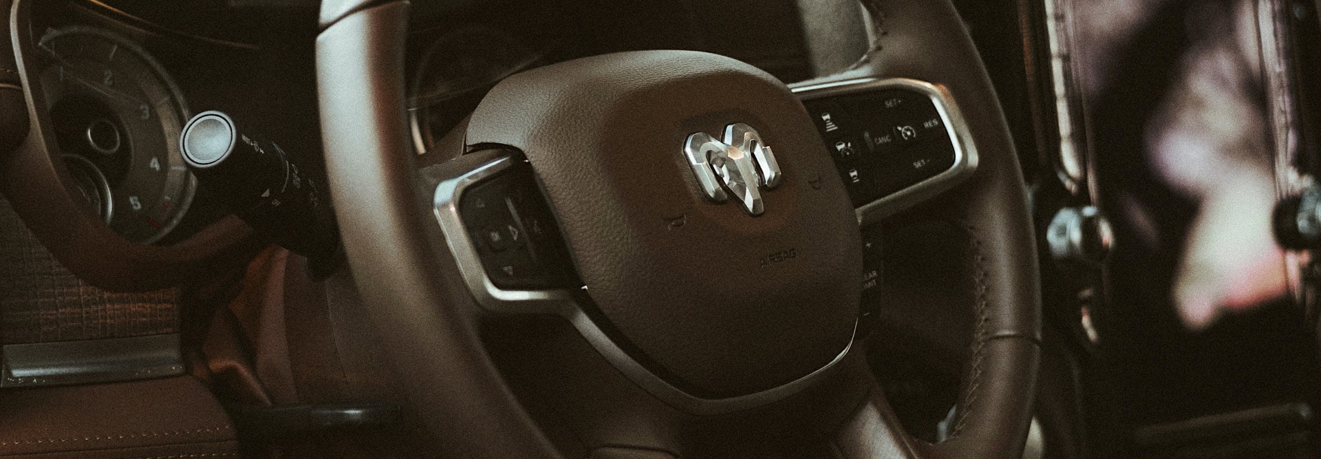 A close-up of the leather-wrapped steering wheel on the 2021 Ram Limited Longhorn 10th Anniversary.