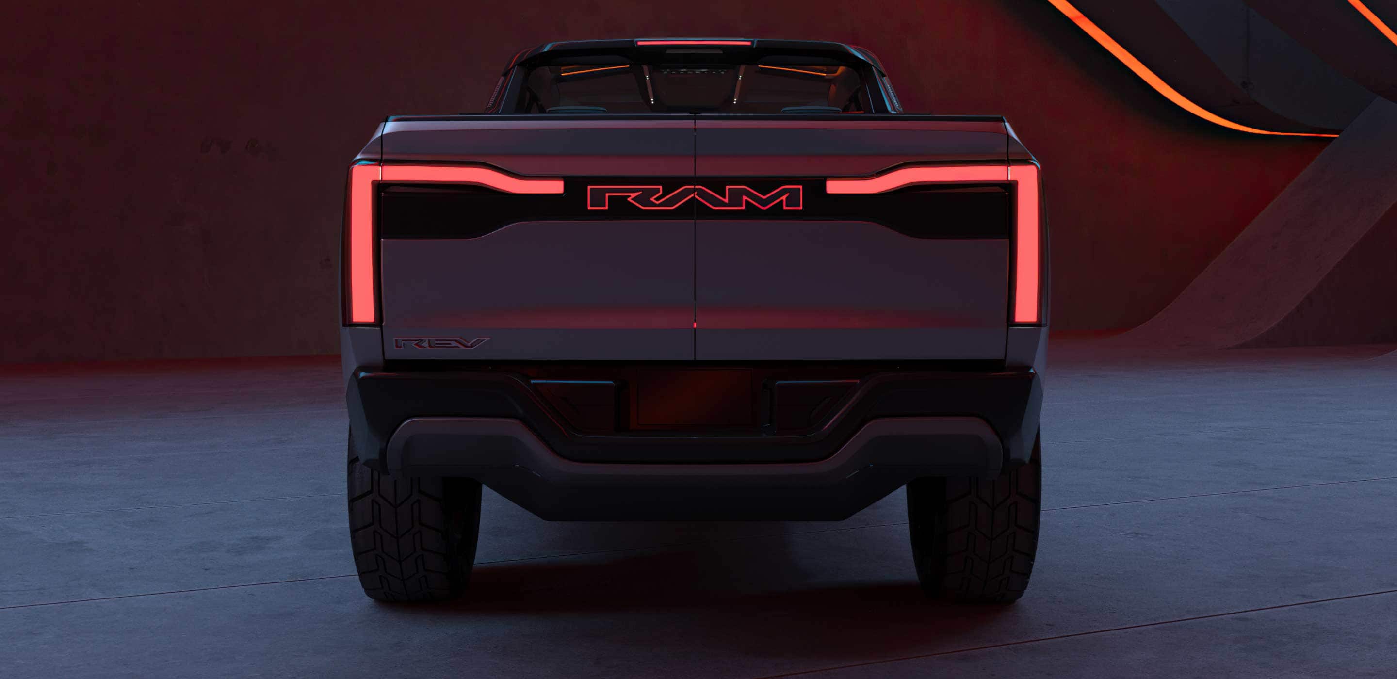 Display A rear view of the Ram Revolution Concept in a studio with a dramatic set design and lighting.