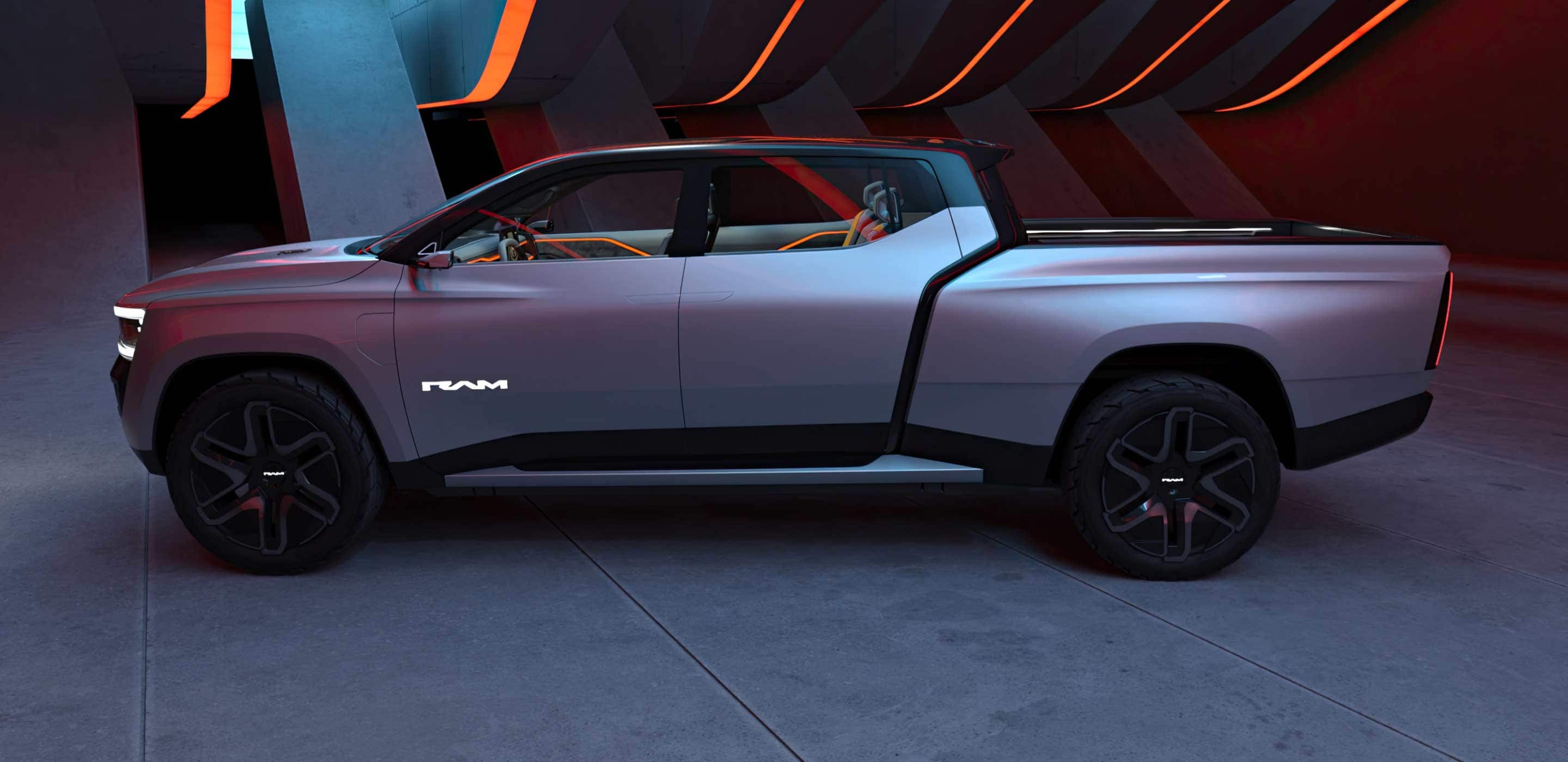 Display A driver-side profile of the Ram Revolution Concept in a studio with a dramatic set design and lighting.
