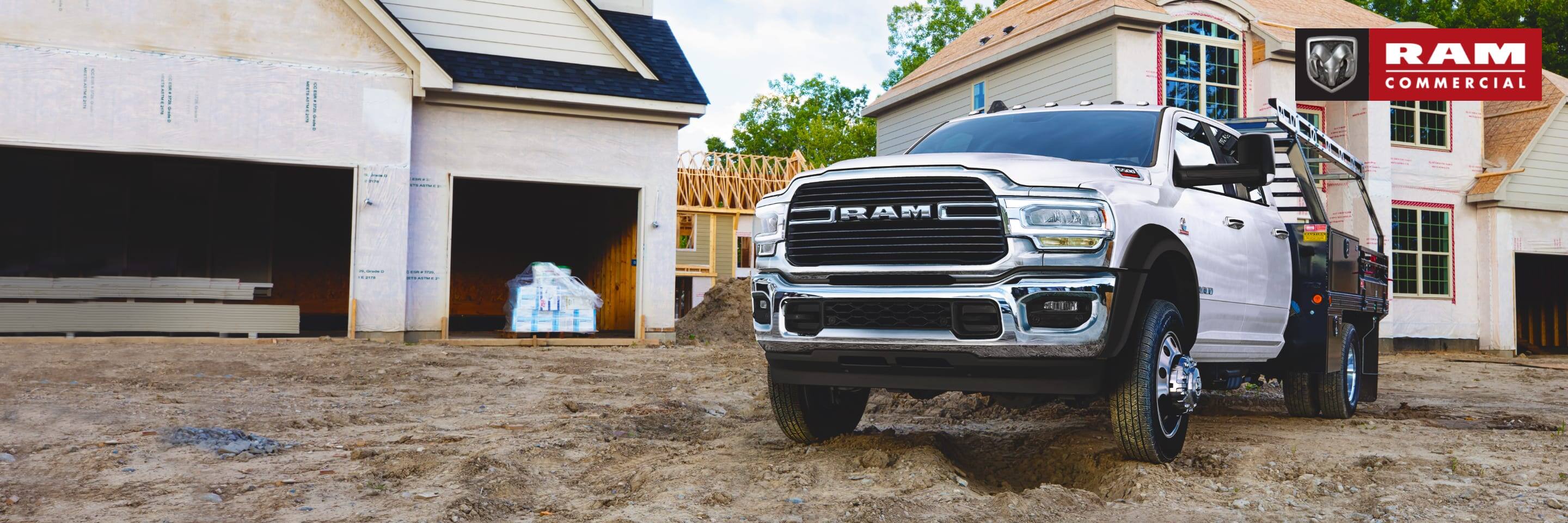 A white 2019 Ram 5500 SLT with a Service Body upfit, parked at a residential construction site.