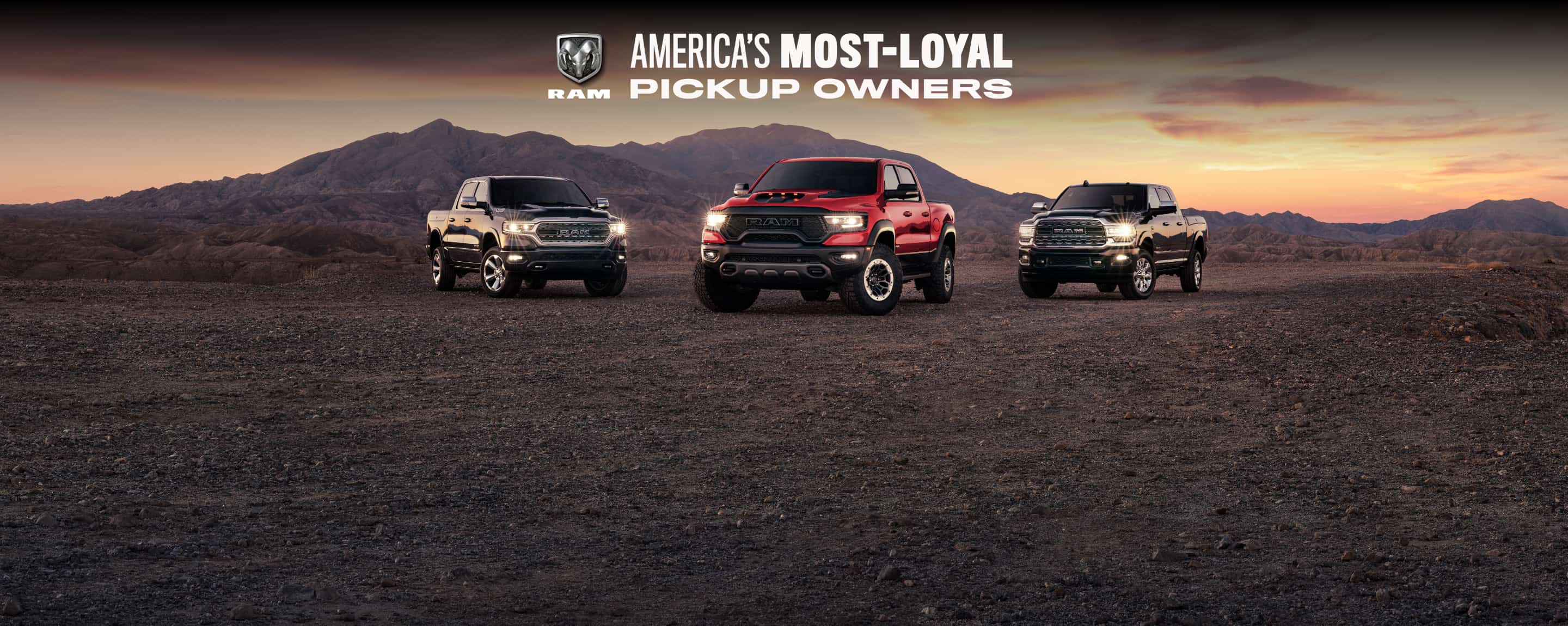 Three 2021 Ram trucks parked on a mountain trail—a Ram 1500 Limited, Ram 1500 TRX and Ram 2500 Limited. Ram, America's Most Loyal Pickup Owners logo.