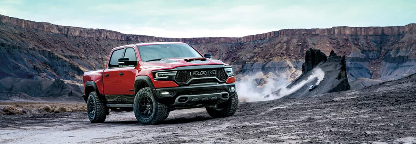 A Ram 1500 TRX truck parked off road in a canyon.