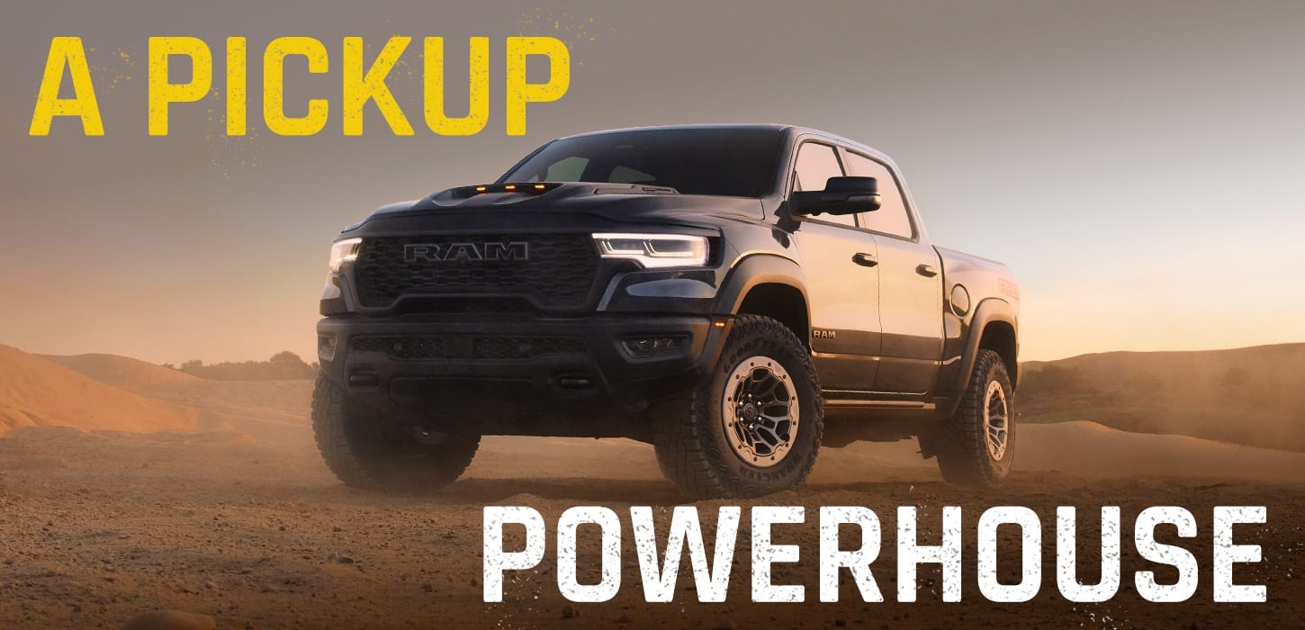 A 2027 Ram 1500 RHO is parked in a rugged environment with the front headlamps shining.