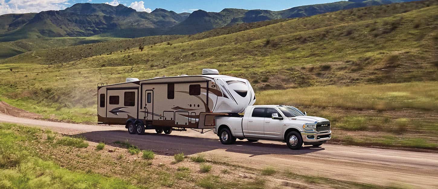 Ram truck towing a boat to the lake