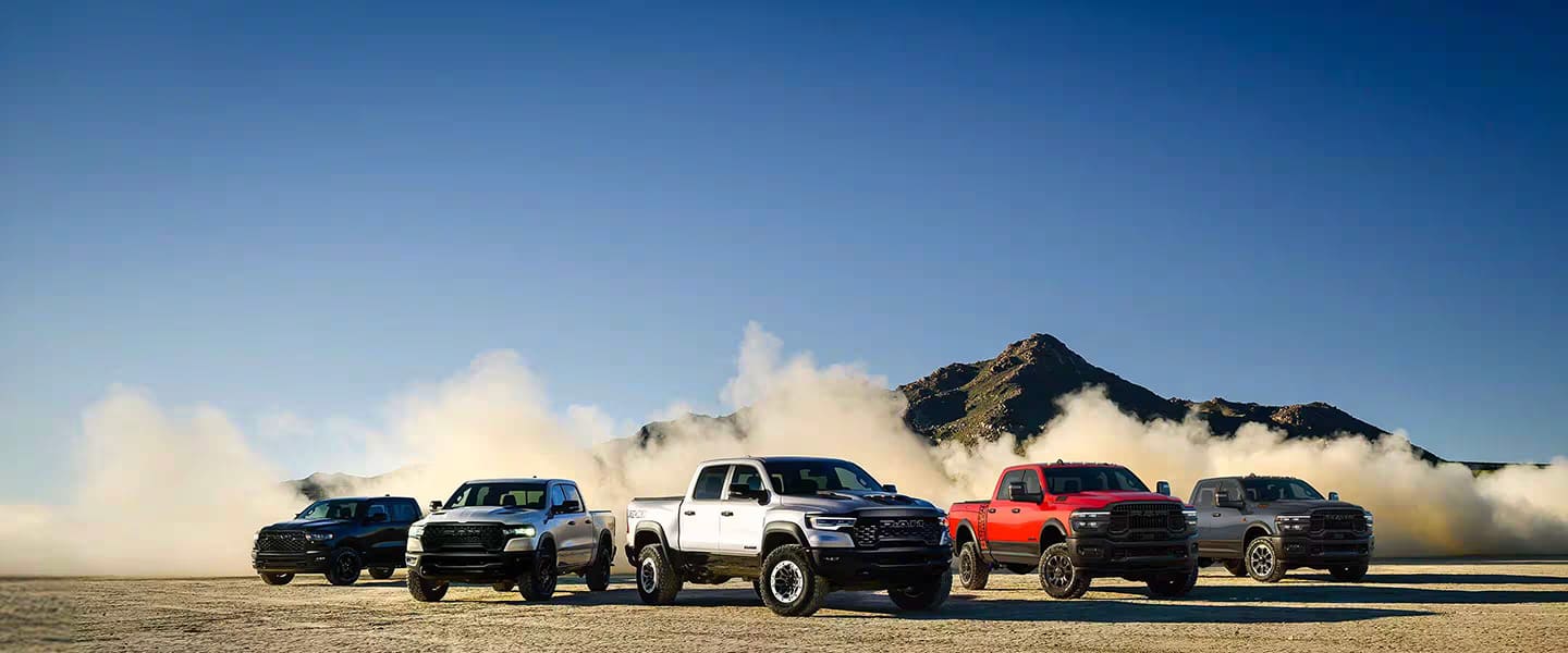 A pack shot of five 2025 Ram Trucks in a desert setting.